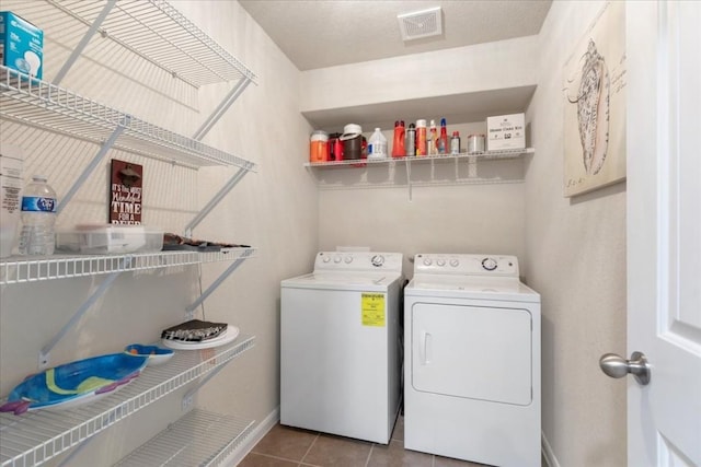 clothes washing area with tile patterned floors and washing machine and dryer