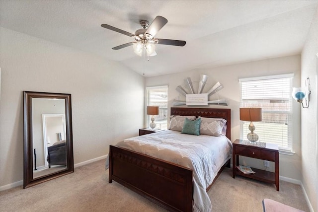 bedroom featuring light carpet, vaulted ceiling, and ceiling fan