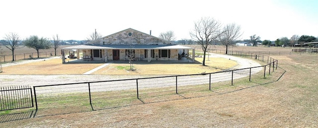 view of front facade featuring a rural view