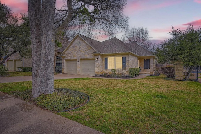 view of front facade featuring a garage and a lawn