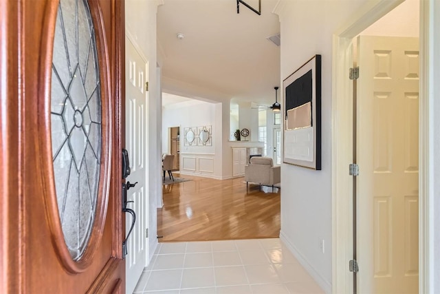 entryway featuring a ceiling fan and tile patterned floors