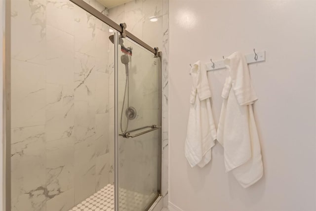 bathroom with a marble finish shower