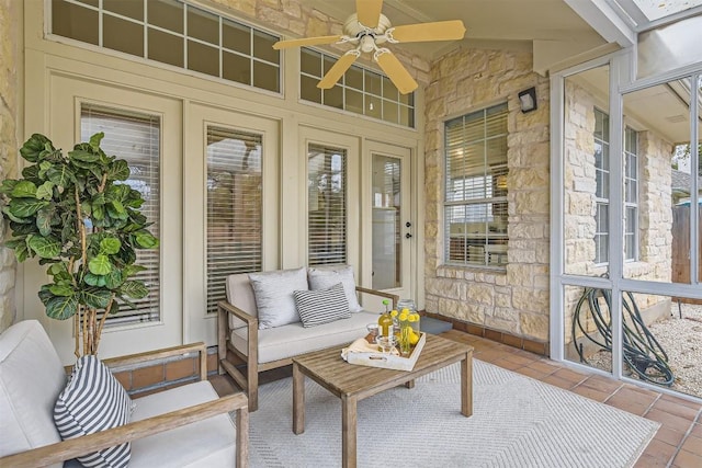 sunroom featuring lofted ceiling and ceiling fan