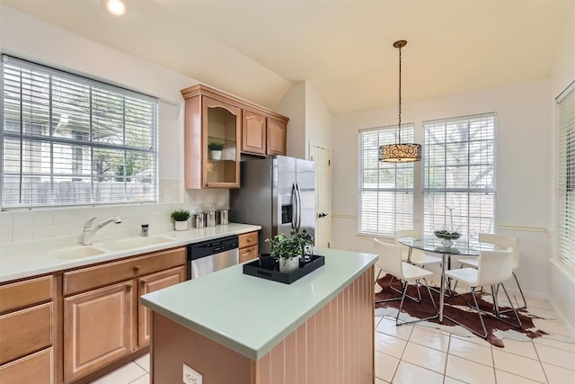 kitchen with stainless steel appliances, vaulted ceiling, a healthy amount of sunlight, and a sink