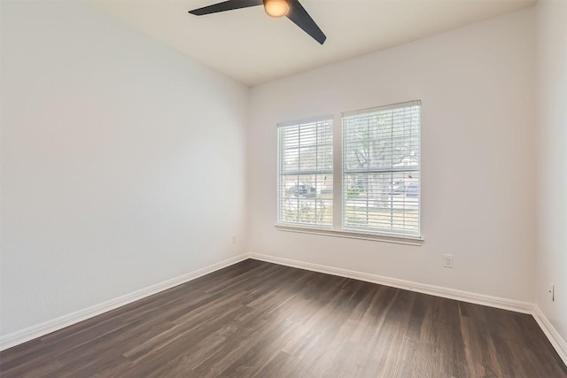 empty room featuring dark wood-type flooring, ceiling fan, and baseboards