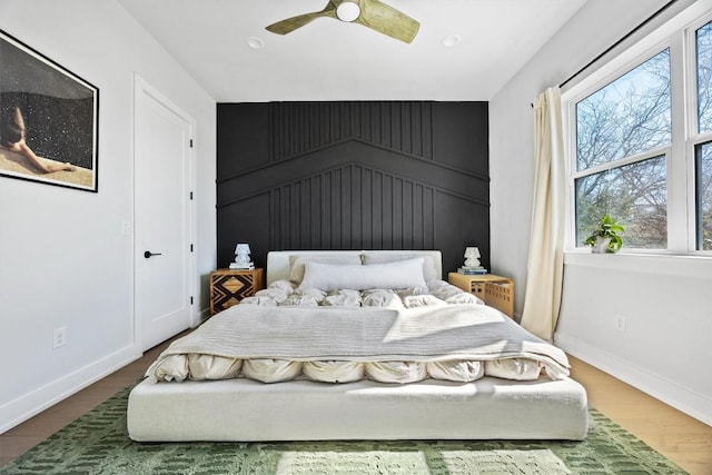 bedroom featuring hardwood / wood-style flooring and ceiling fan