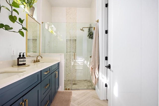 bathroom with vanity, a tile shower, and parquet floors