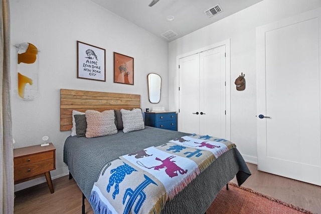 bedroom with hardwood / wood-style floors and a closet