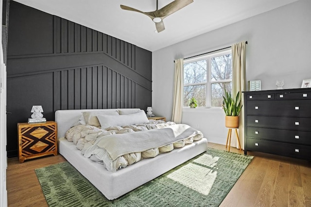 bedroom with hardwood / wood-style floors and ceiling fan