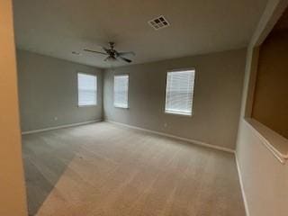 spare room featuring ceiling fan and light carpet