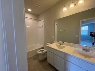 full bathroom with vanity, shower / washtub combination, and toilet