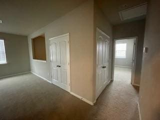 corridor with light colored carpet