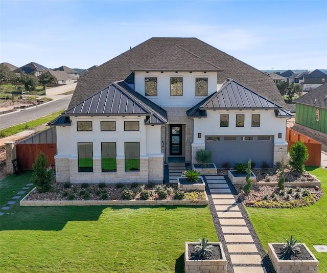 view of front of house featuring a garage and a front yard