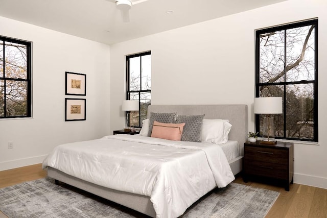 bedroom with ceiling fan and wood-type flooring