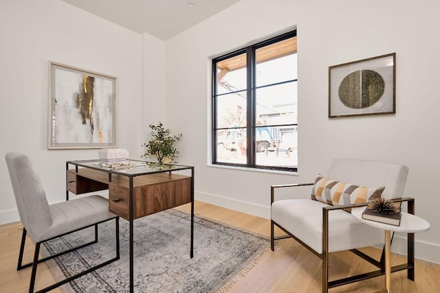 home office with light hardwood / wood-style floors