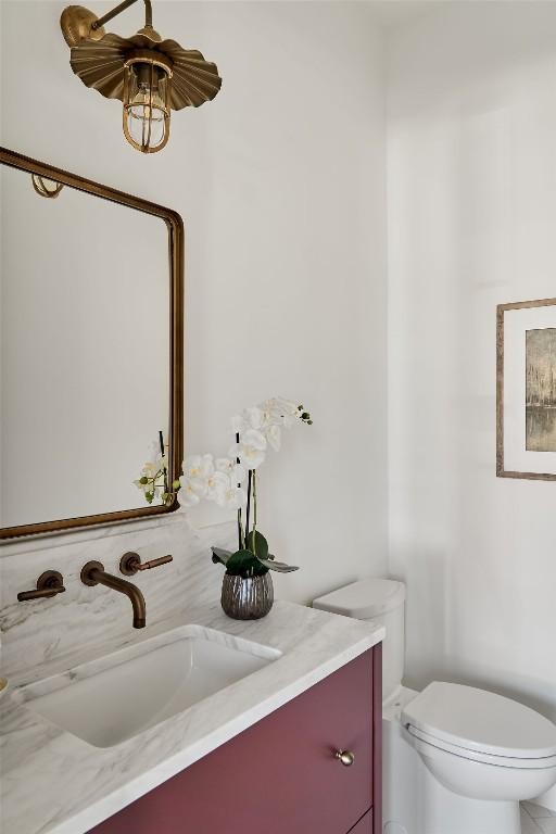 bathroom featuring vanity and toilet