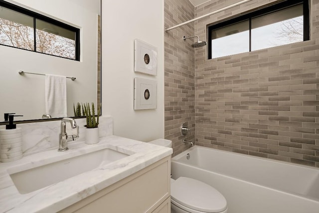 full bathroom featuring tiled shower / bath combo, vanity, tasteful backsplash, and toilet