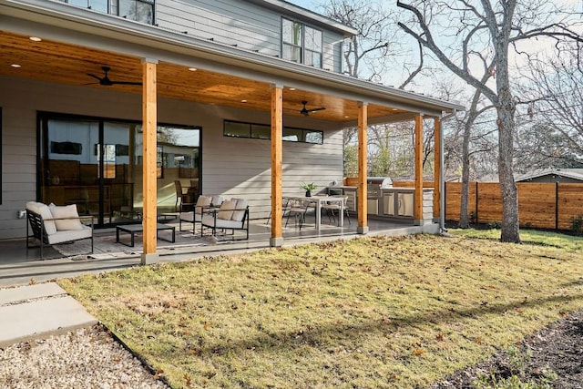 rear view of property with a patio and ceiling fan