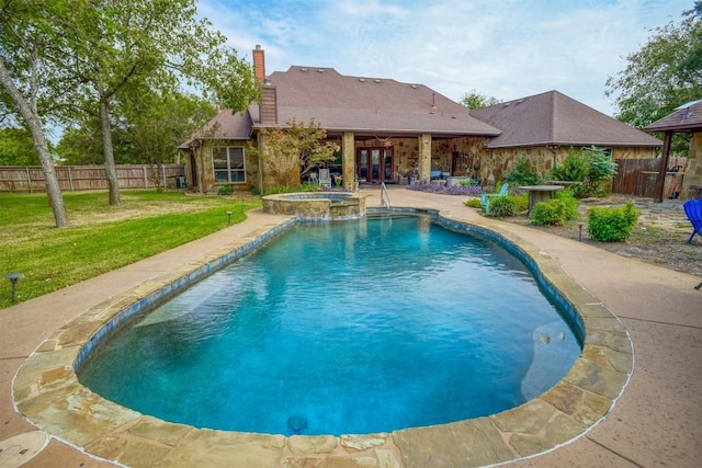 view of swimming pool with a yard, a patio area, and an in ground hot tub