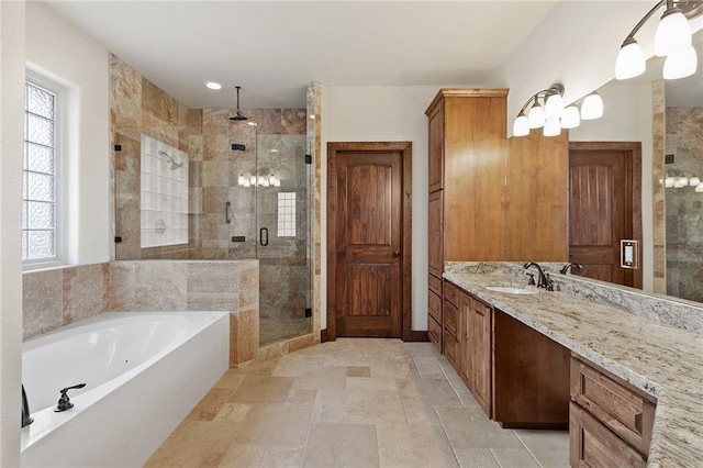 bathroom featuring vanity and independent shower and bath