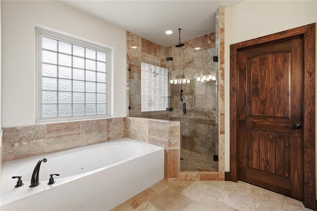 bathroom featuring shower with separate bathtub