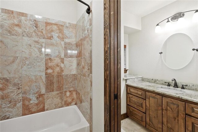 bathroom featuring vanity, tile patterned floors, and tiled shower / bath