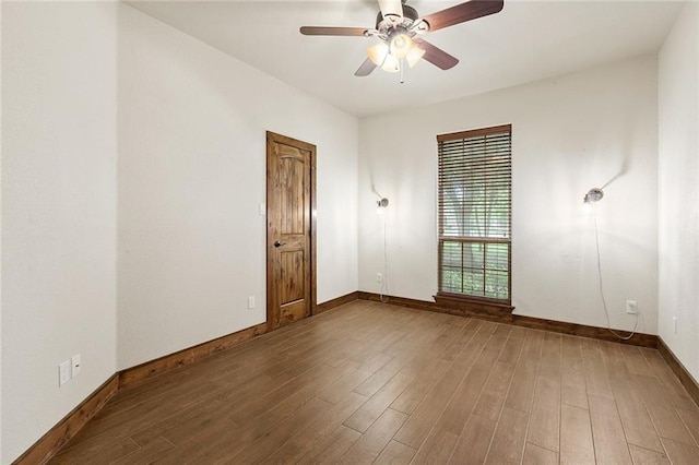 empty room with hardwood / wood-style flooring and ceiling fan