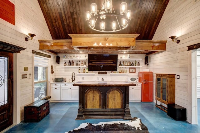 interior space with hanging light fixtures, white cabinets, a breakfast bar, wooden ceiling, and a kitchen island