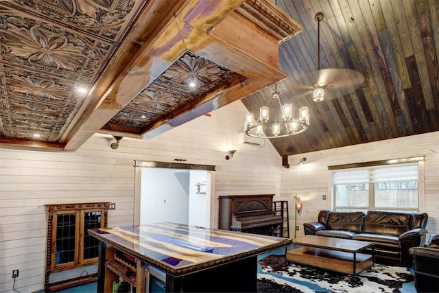 living room with high vaulted ceiling, an inviting chandelier, and wooden walls