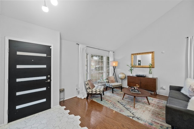 entryway with lofted ceiling and hardwood / wood-style floors