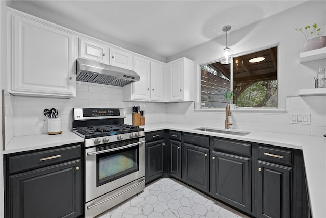 kitchen with gas stove, sink, exhaust hood, and white cabinets