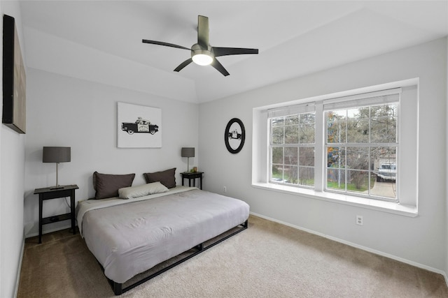 carpeted bedroom featuring lofted ceiling and ceiling fan