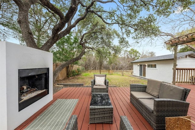 wooden deck featuring an outdoor living space with a fireplace