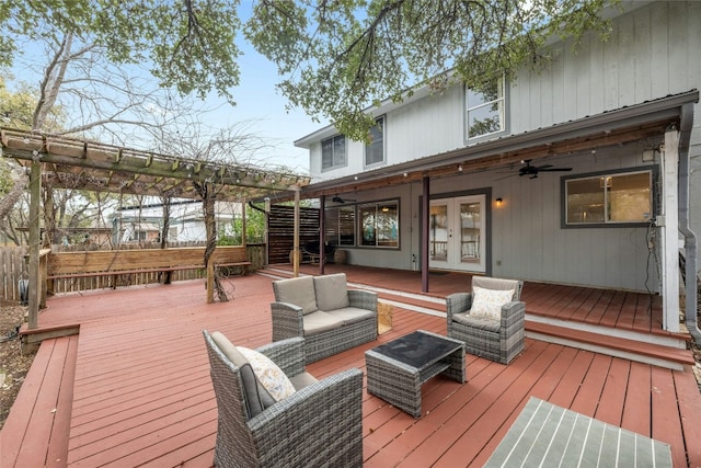 wooden terrace with an outdoor living space, ceiling fan, and french doors