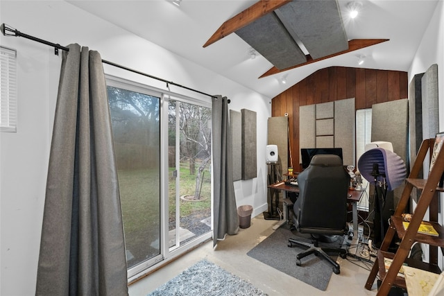 office area with wooden walls and vaulted ceiling