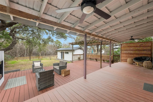 deck featuring ceiling fan, outdoor lounge area, and an outdoor structure