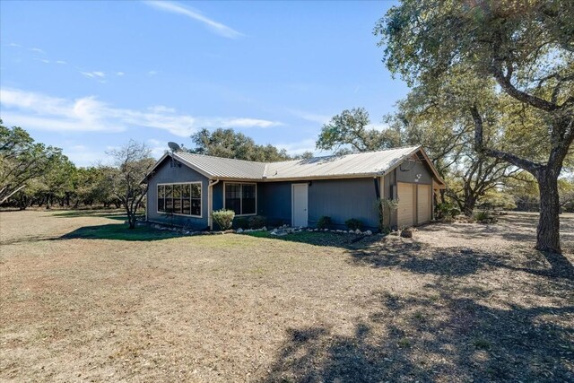 ranch-style house featuring a garage and a front yard