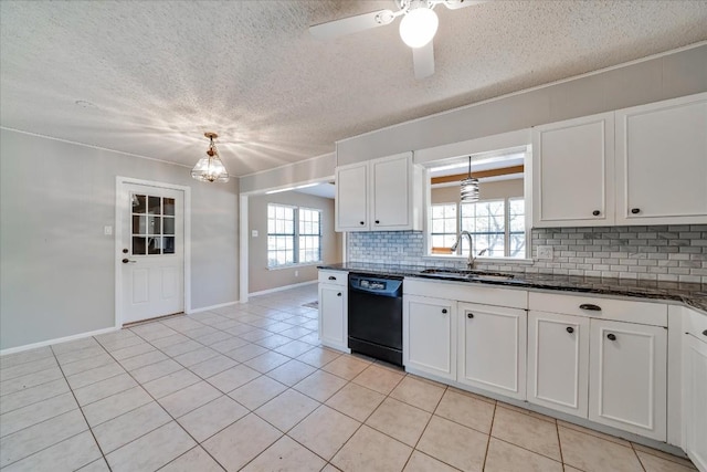 kitchen featuring dishwasher, sink, white cabinets, and dark stone counters