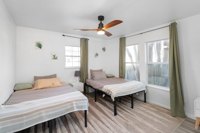 bedroom with ceiling fan and light hardwood / wood-style floors