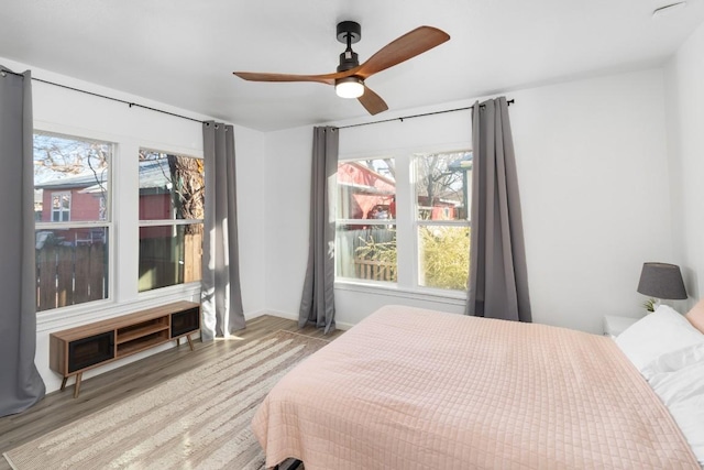 bedroom featuring ceiling fan and light hardwood / wood-style flooring