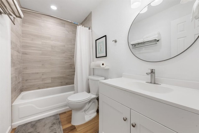 full bathroom with vanity, wood-type flooring, toilet, and shower / bath combo with shower curtain