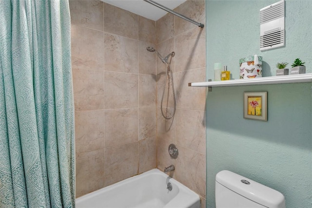 bathroom featuring shower / tub combo and toilet