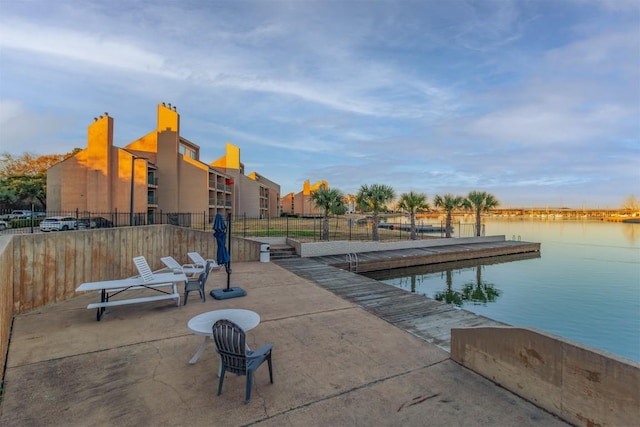 view of community with a boat dock and a water view