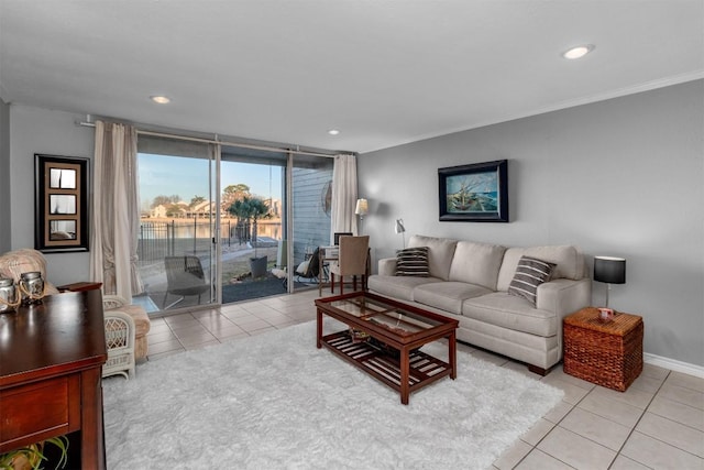 tiled living room featuring crown molding and a wall of windows