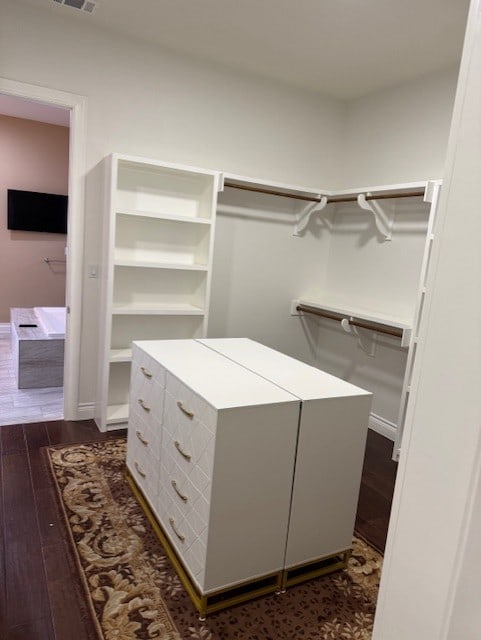 spacious closet with dark hardwood / wood-style floors