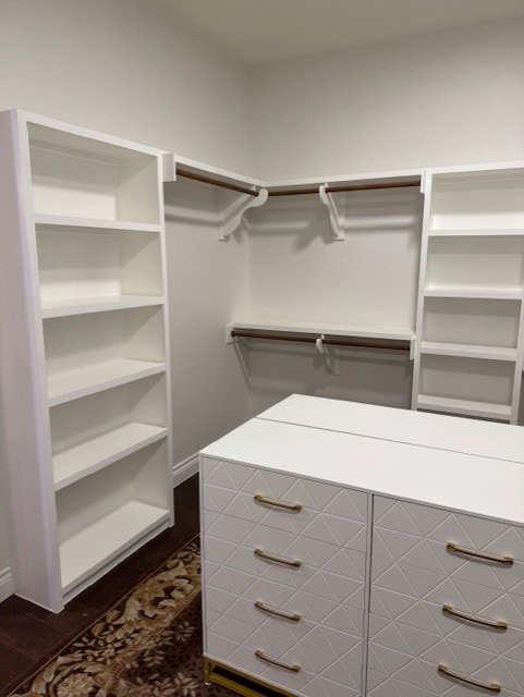 walk in closet featuring dark hardwood / wood-style floors