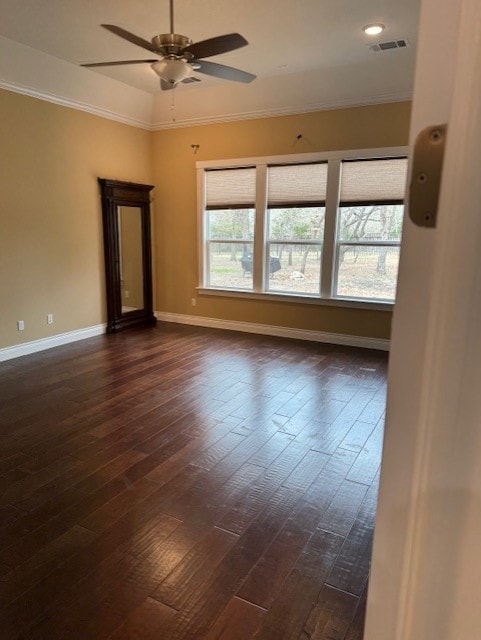 spare room featuring crown molding, ceiling fan, and dark hardwood / wood-style flooring