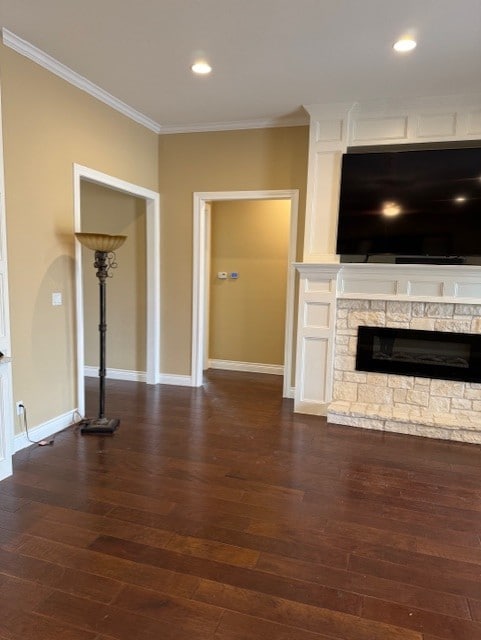 unfurnished living room featuring a fireplace, ornamental molding, and dark hardwood / wood-style floors