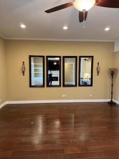 spare room featuring ceiling fan, ornamental molding, and dark hardwood / wood-style floors