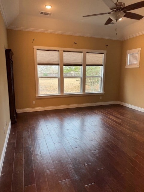 spare room with crown molding, dark hardwood / wood-style floors, and ceiling fan